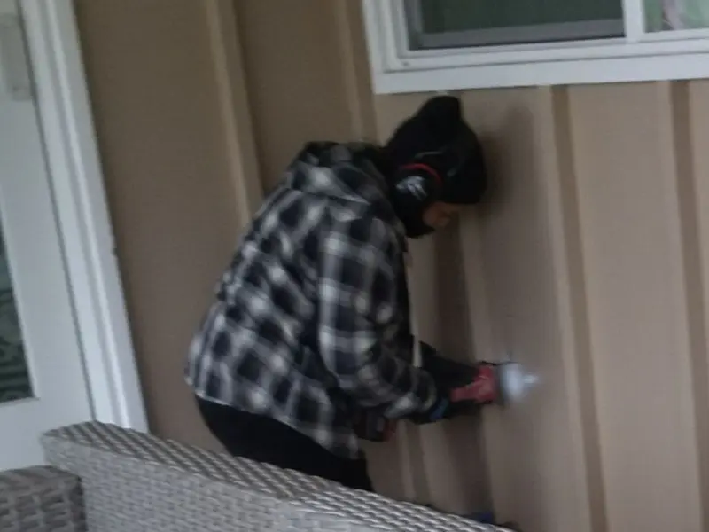 Professional electrician installing an exterior outlet in Scotia
